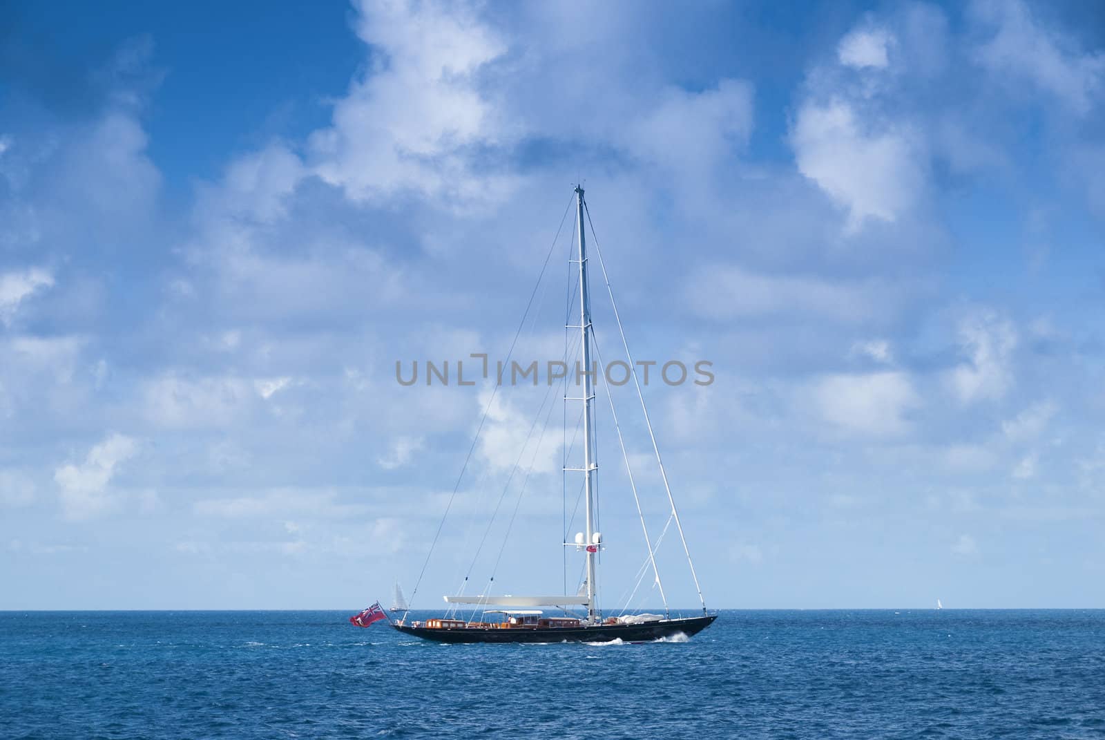 Large sailboat moving between islands in the caribbean