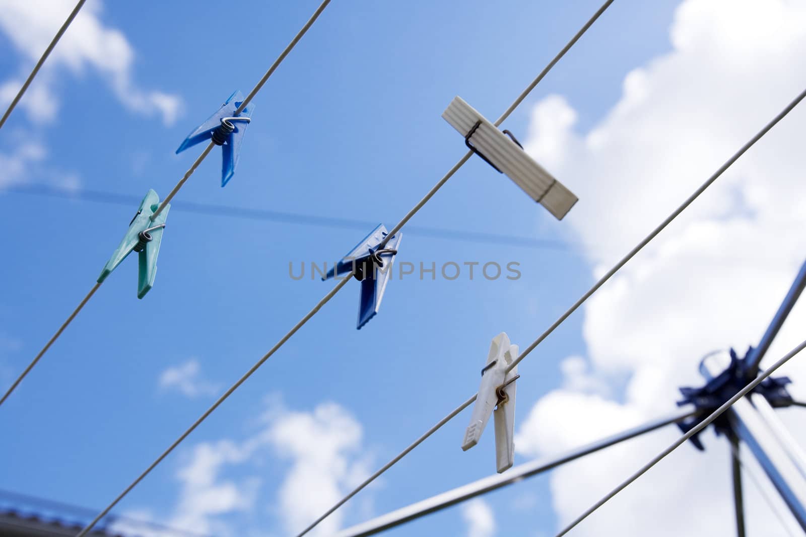 Clothespins with selective focus towards blue sky