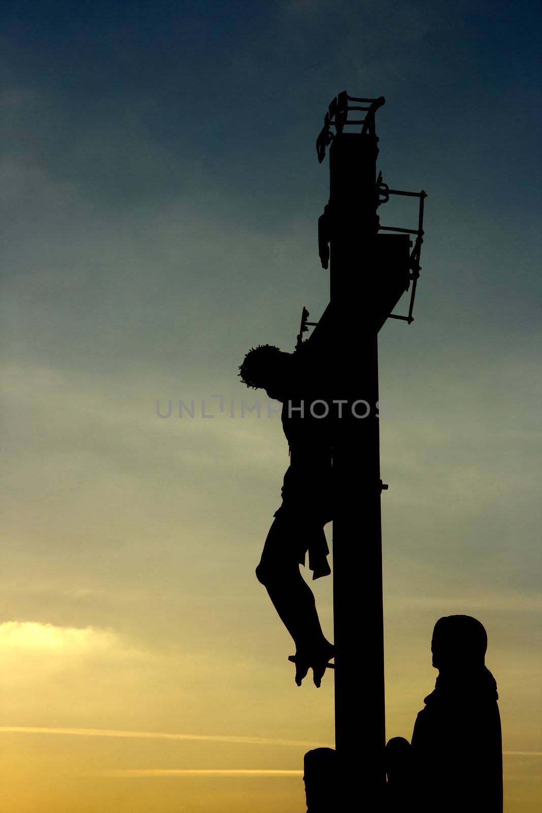 Easter concept - Jesus Christ crucified against sunset background
