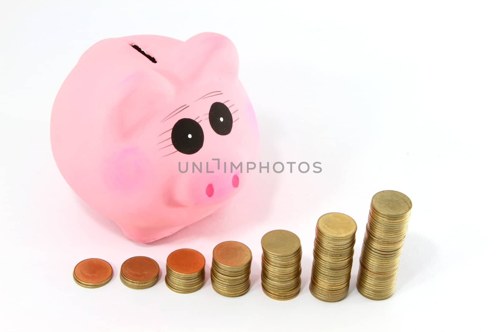 Piggy bank and coins isolated on white 
 by rufous