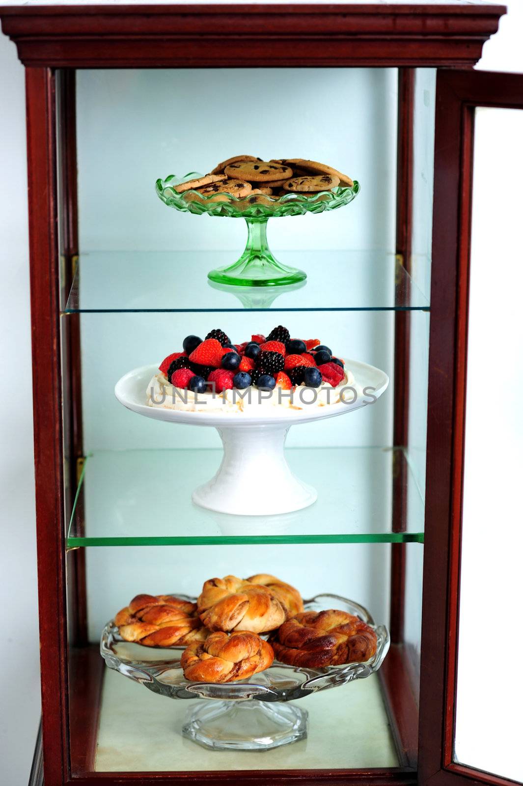 Shelf decorated by delicious desserts by stockyimages