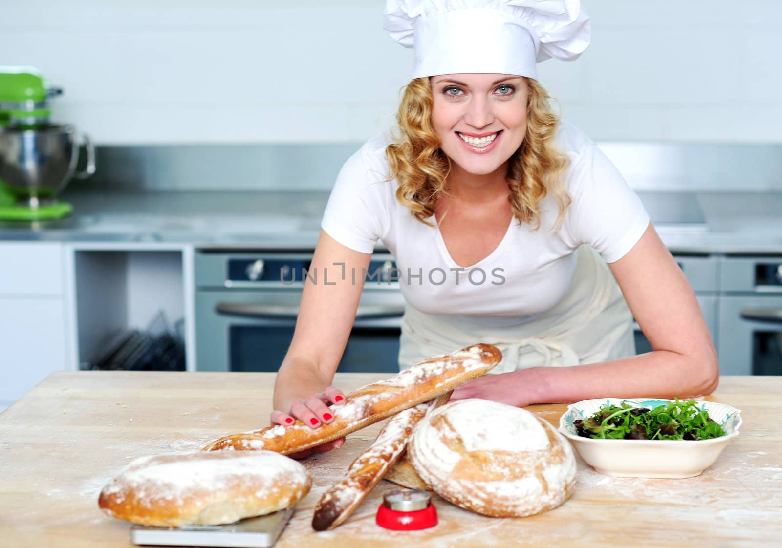 Bakery woman preparing healthy food. Looking and smiling at camera