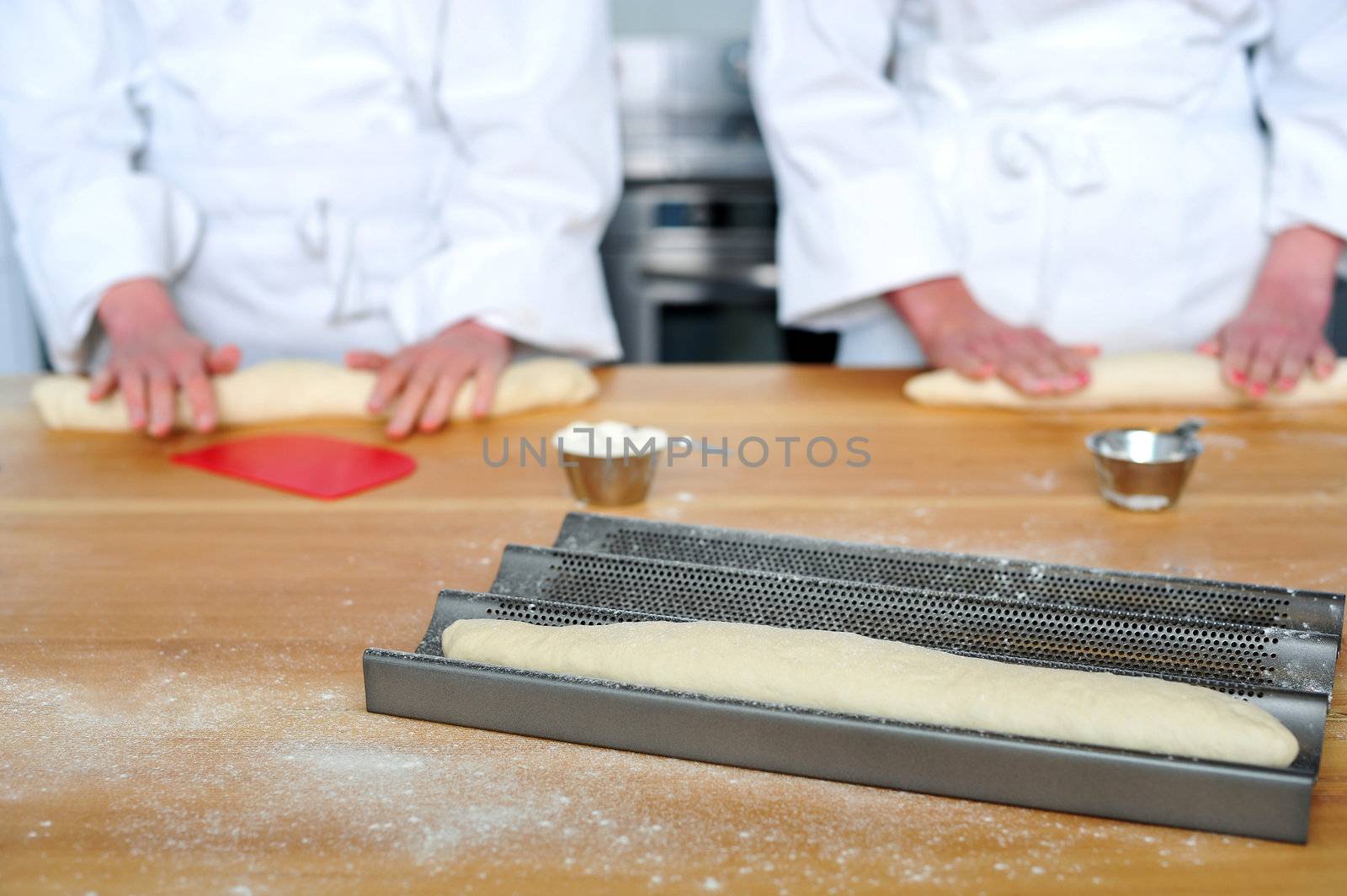 Rolling the dough with hands by stockyimages