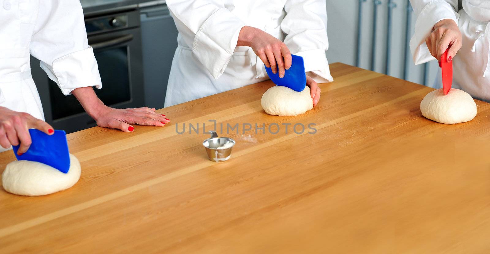Women hands kneading dough. Bakery preparation