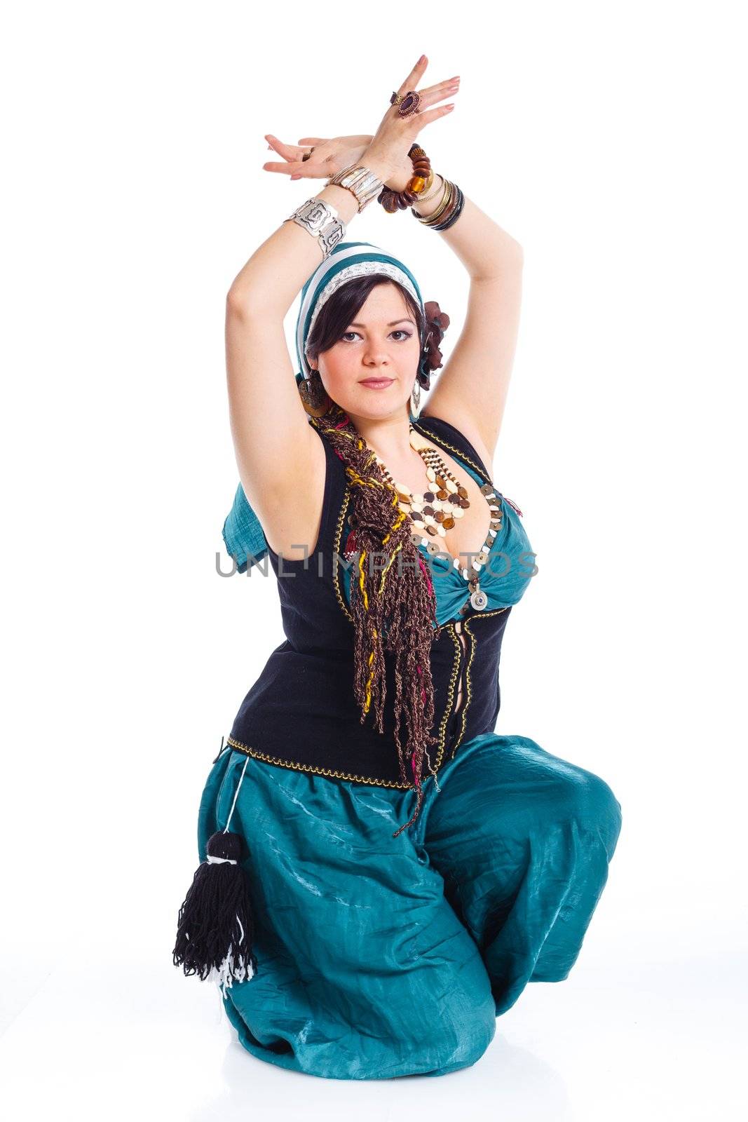 Oriental dancer in blue costume over white background