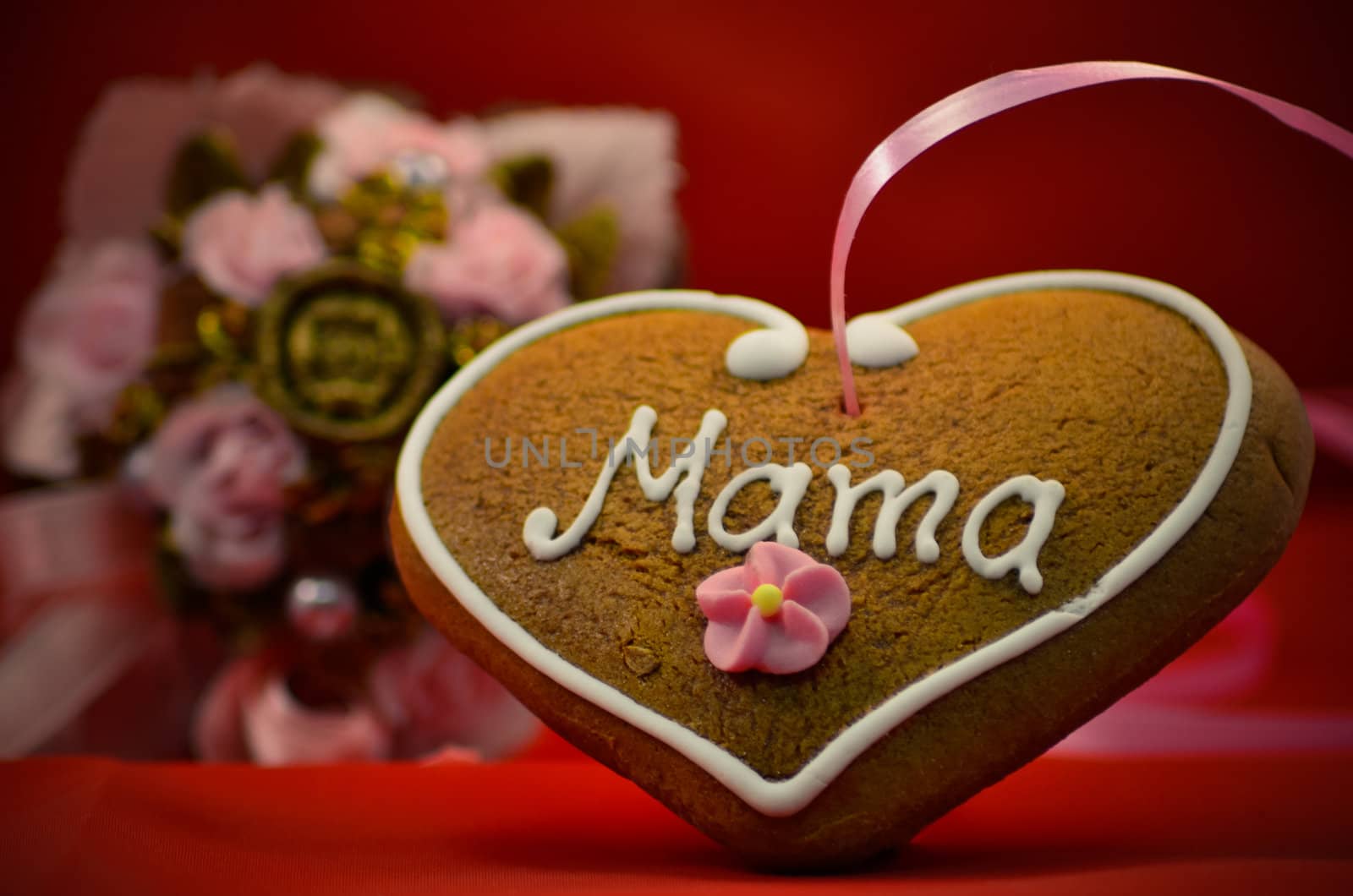 Mothers day gingerbread heart with bouqet in background