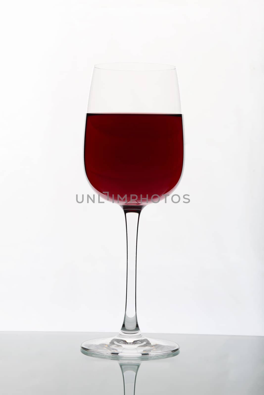 Glasses with wine on the color background