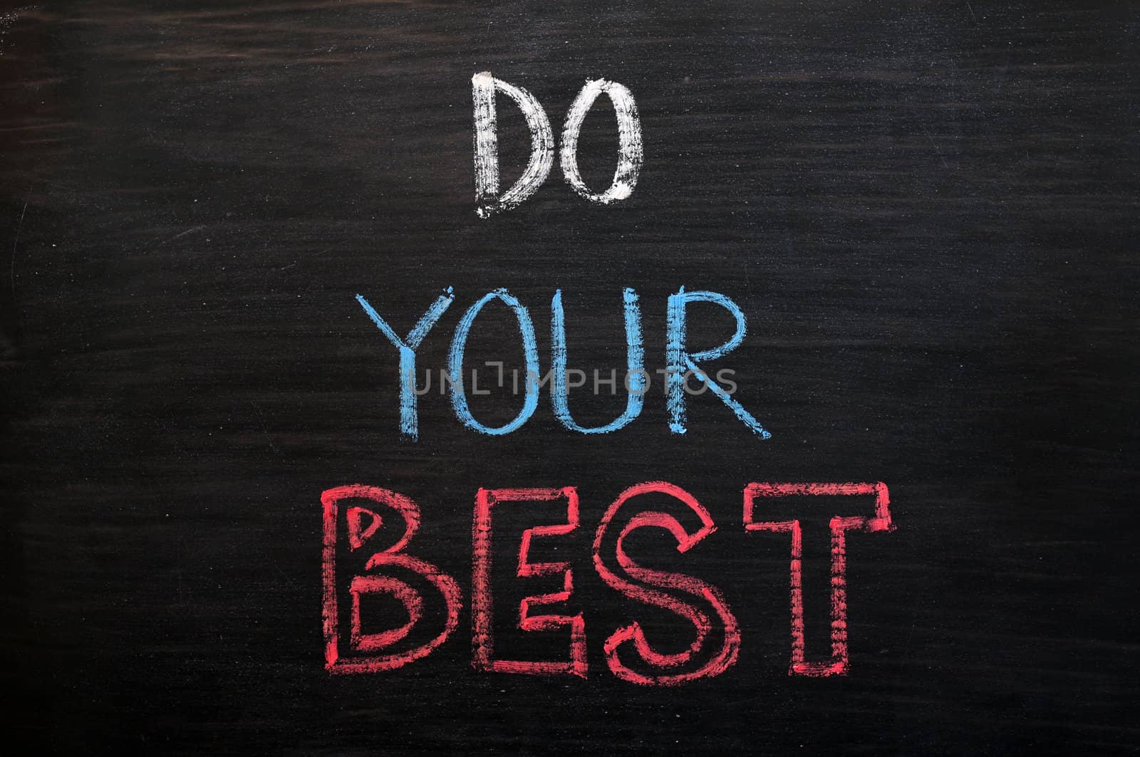 Do your best - words written with chalk on a wooden blackboard