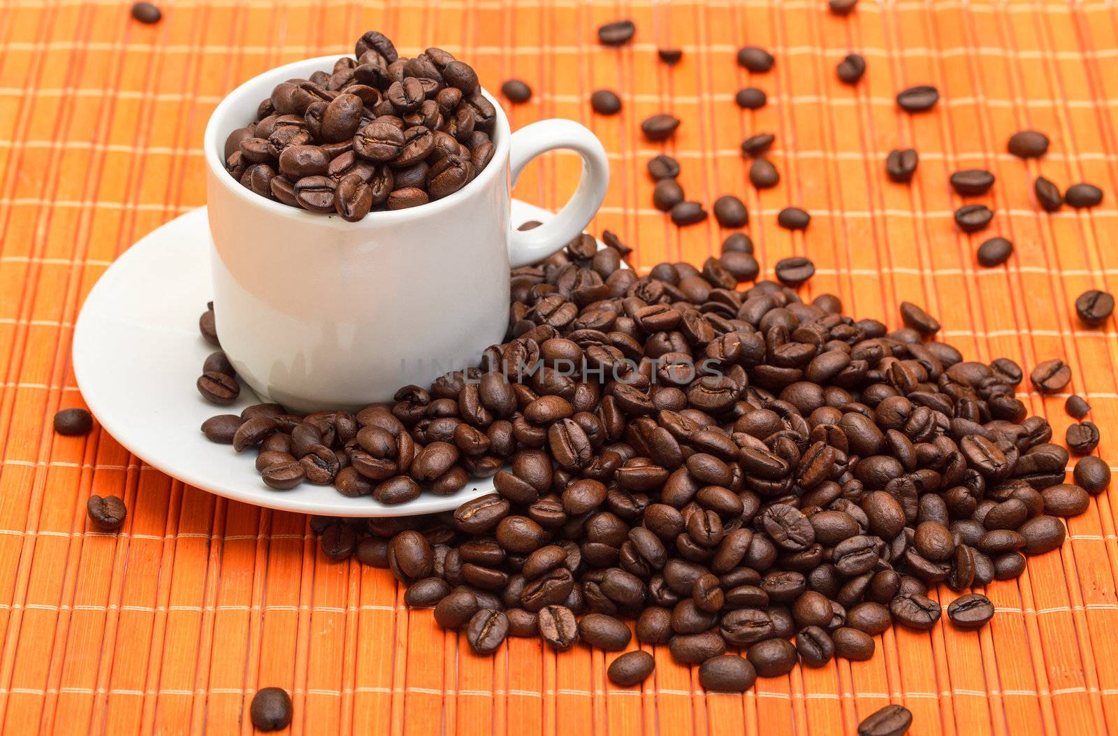 Cup with Coffee Beans on Bamboo Mat