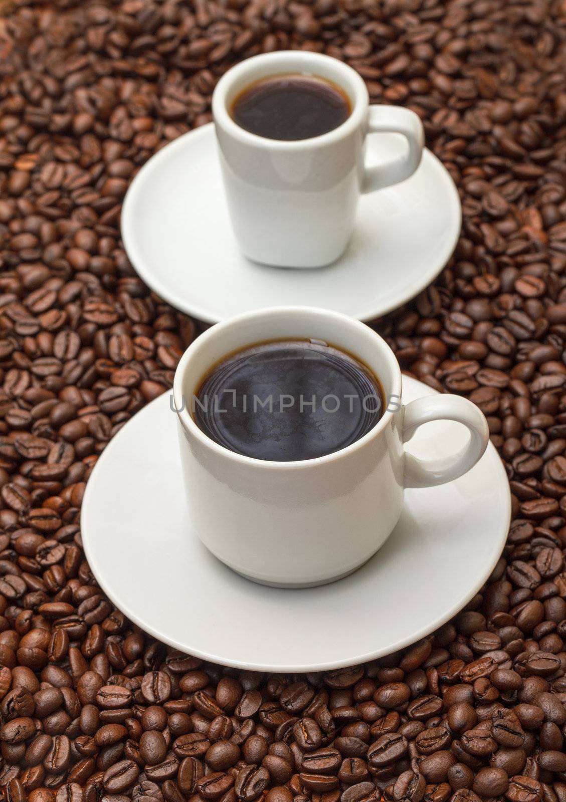 Cups with Hot Coffee on Coffee Beans  by Discovod