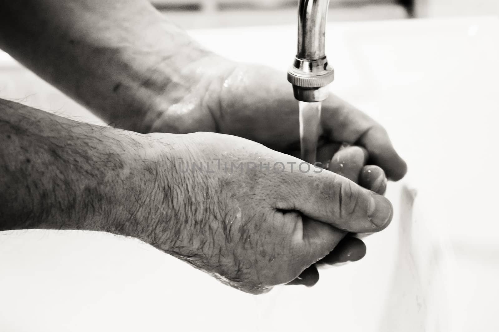 Hands washing in basin by ryhor