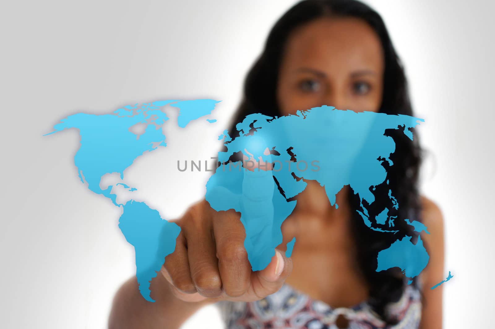 Young latin woman pointing with a finger iof a world map.