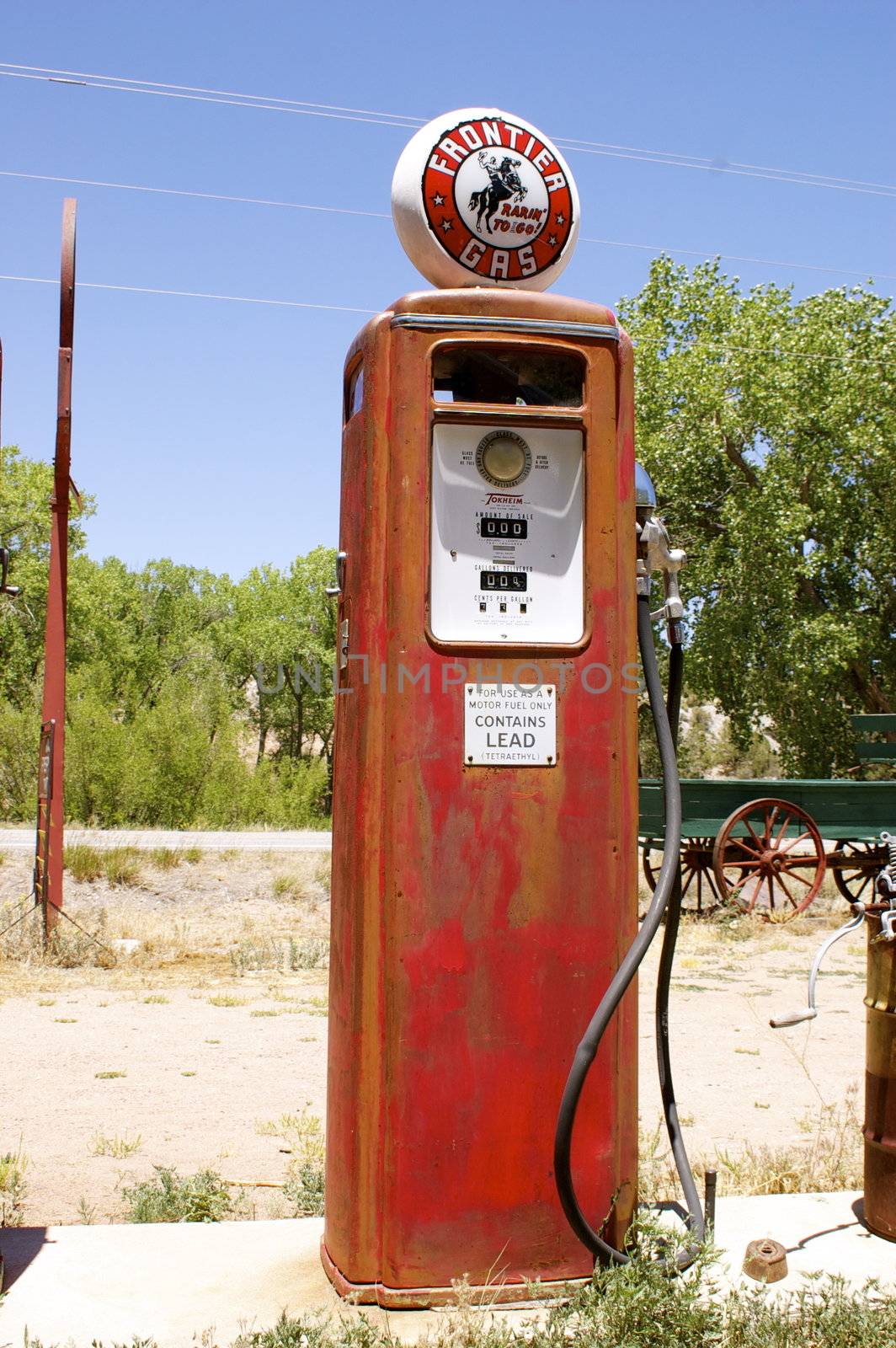 Single old fashioned, vintage red fuel (gas/ petrol) pump, outdoors.