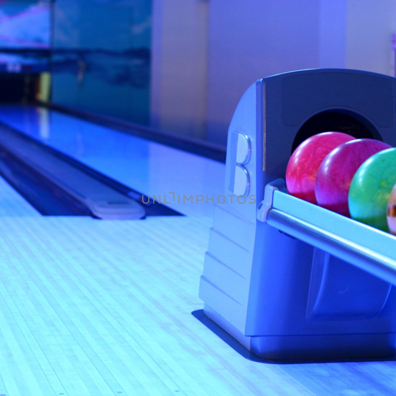 colored bowling bolls in a row 