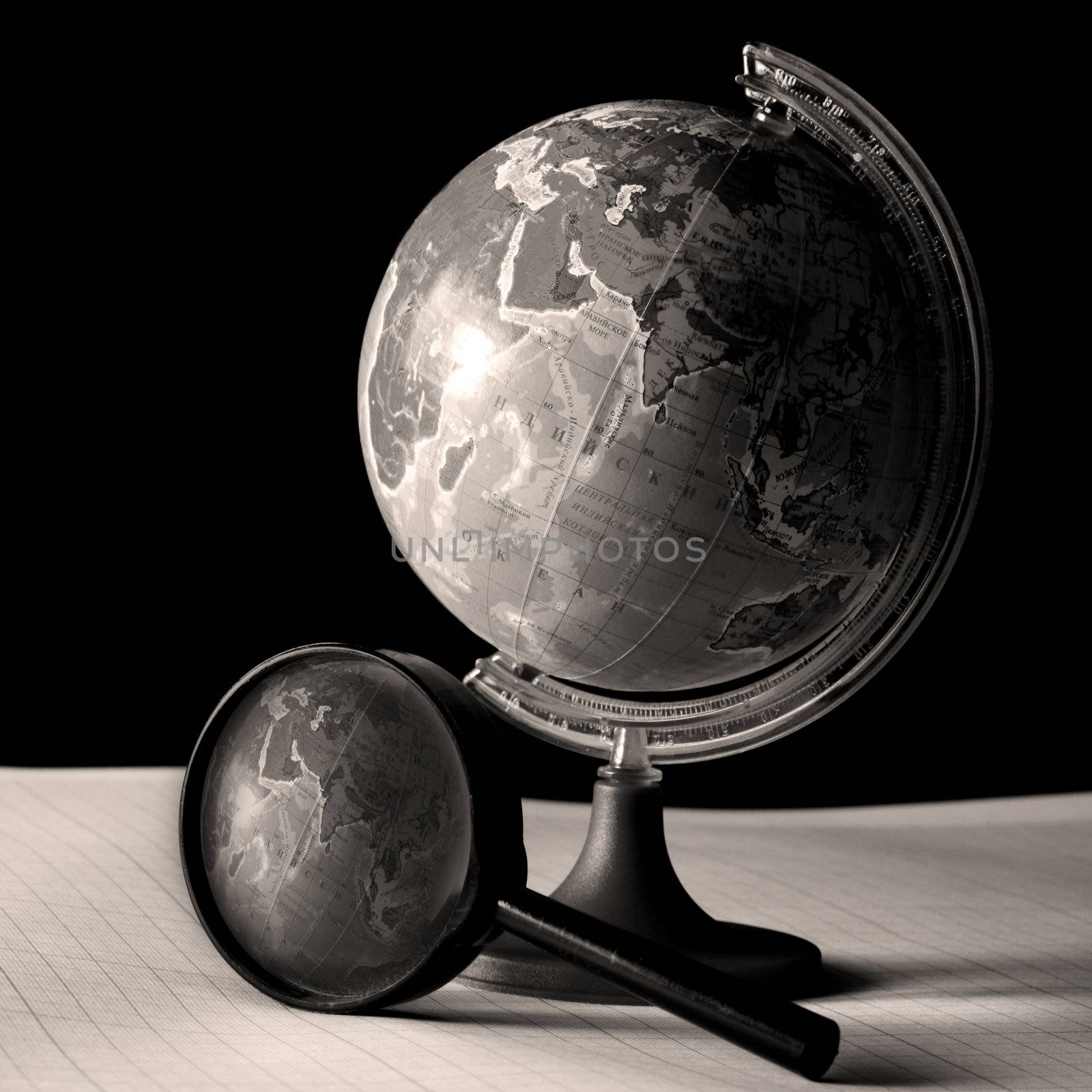 earth globe and magnifier in dark