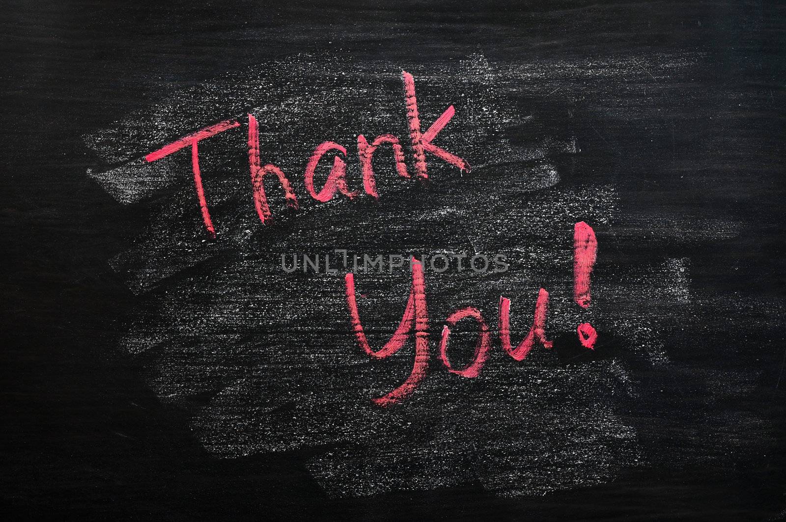 Thank you written with red chalk on a smudged blackboard
