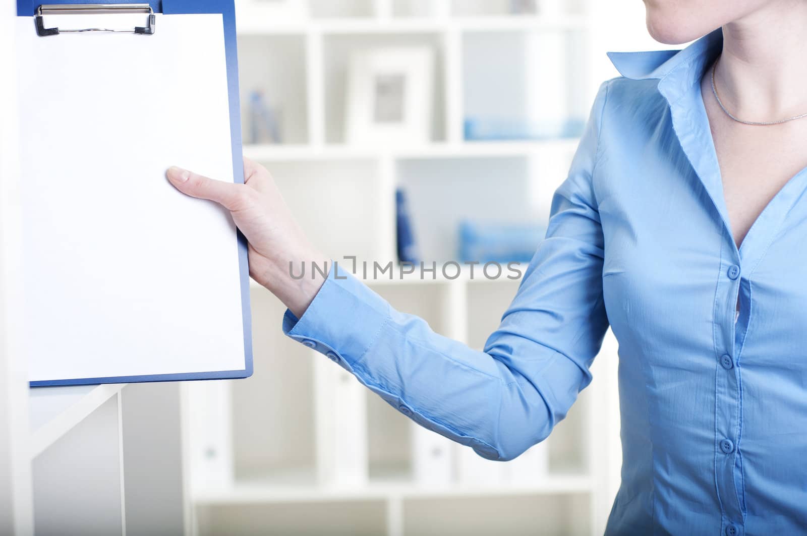 woman puts a tablet with documents in a rack for documents