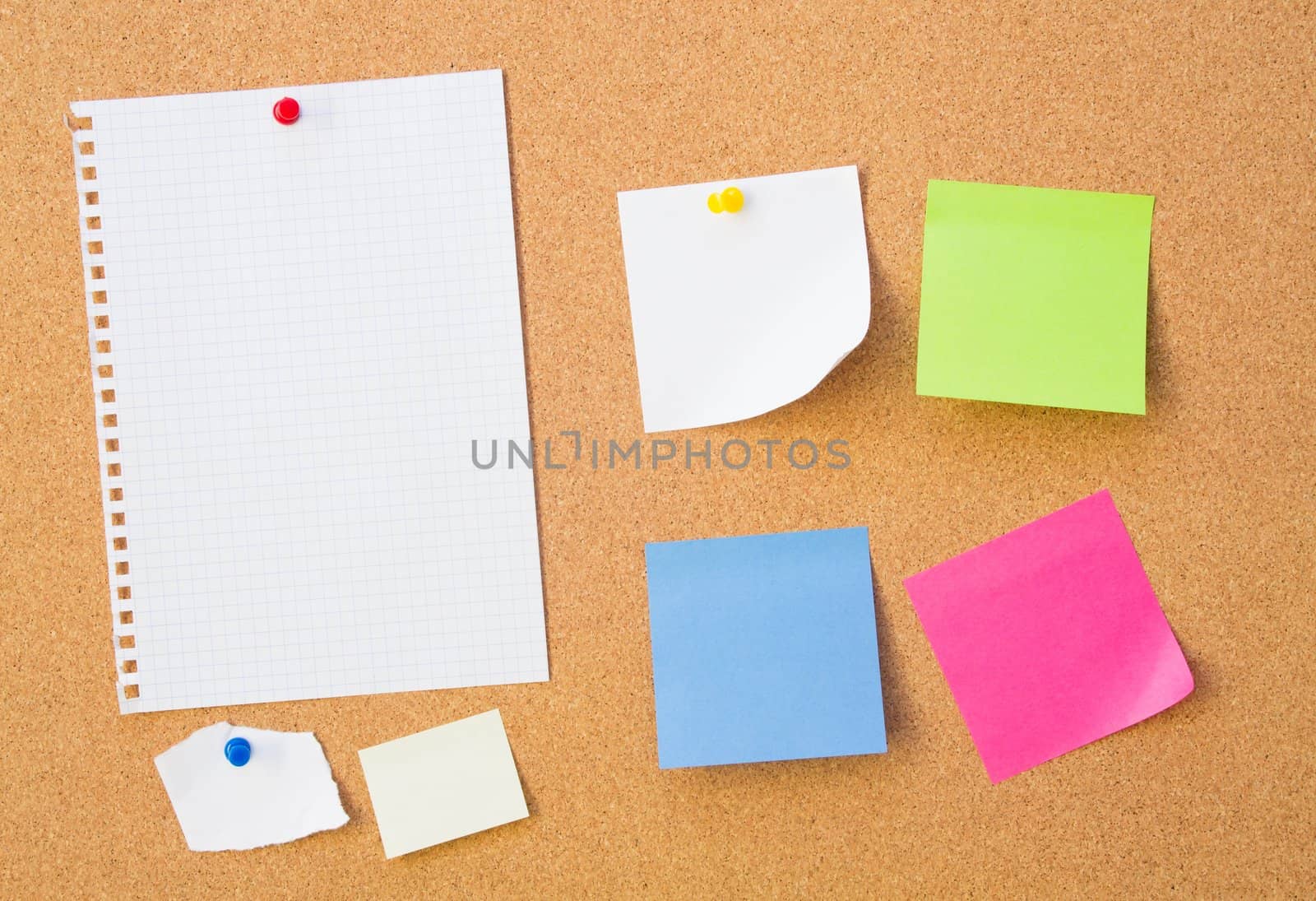 Colour note papers on pin board. Cork background 