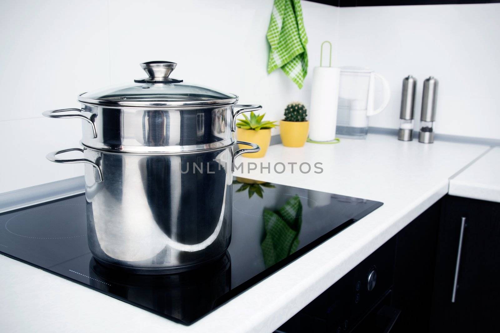 Big pot in modern kitchen with induction stove 