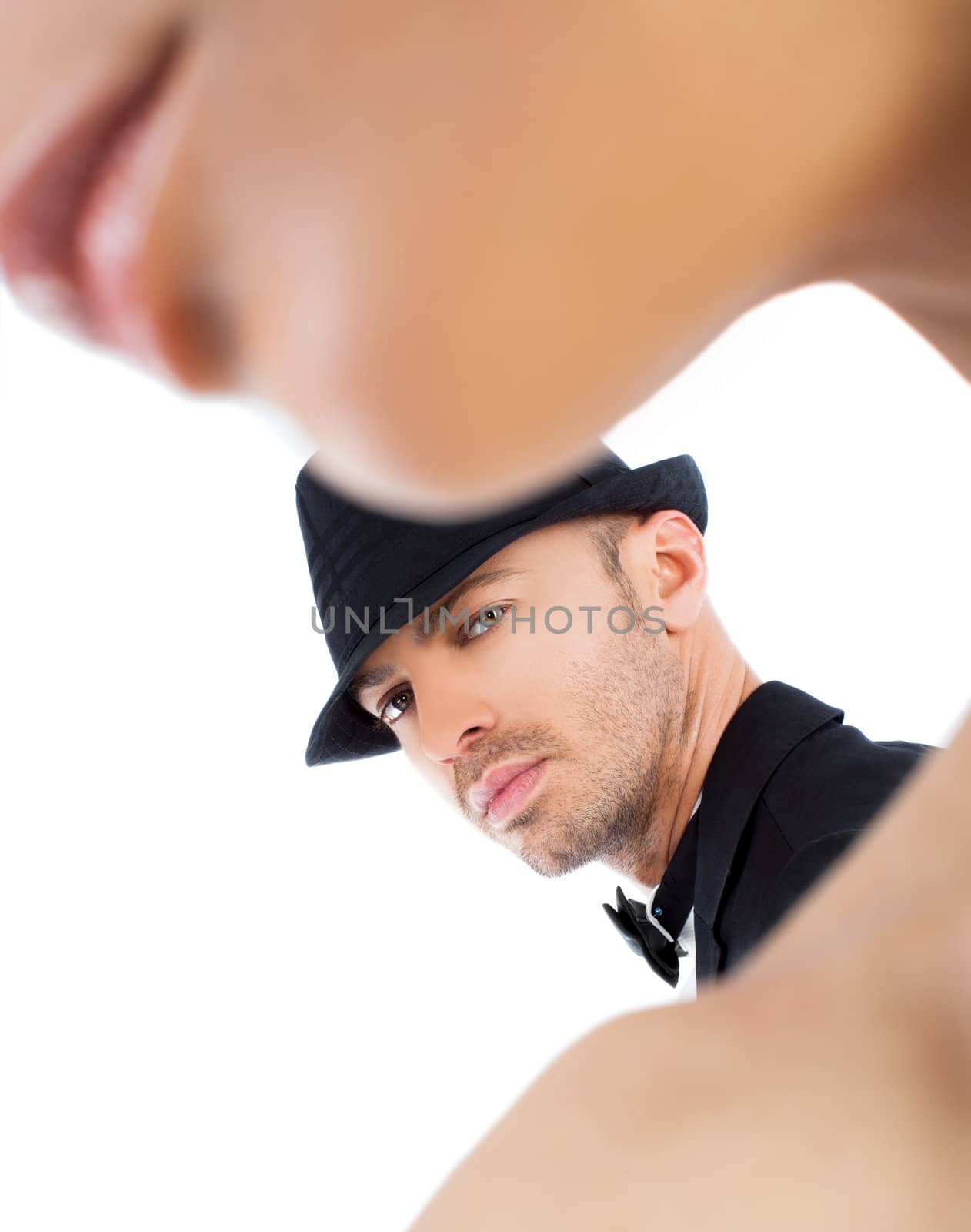 Young man with black hat behind woman silhouette