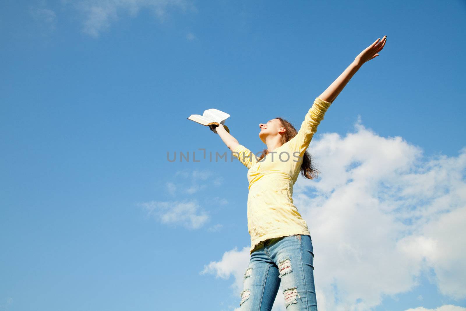 Young woman staying with raised hands by AndreyKr