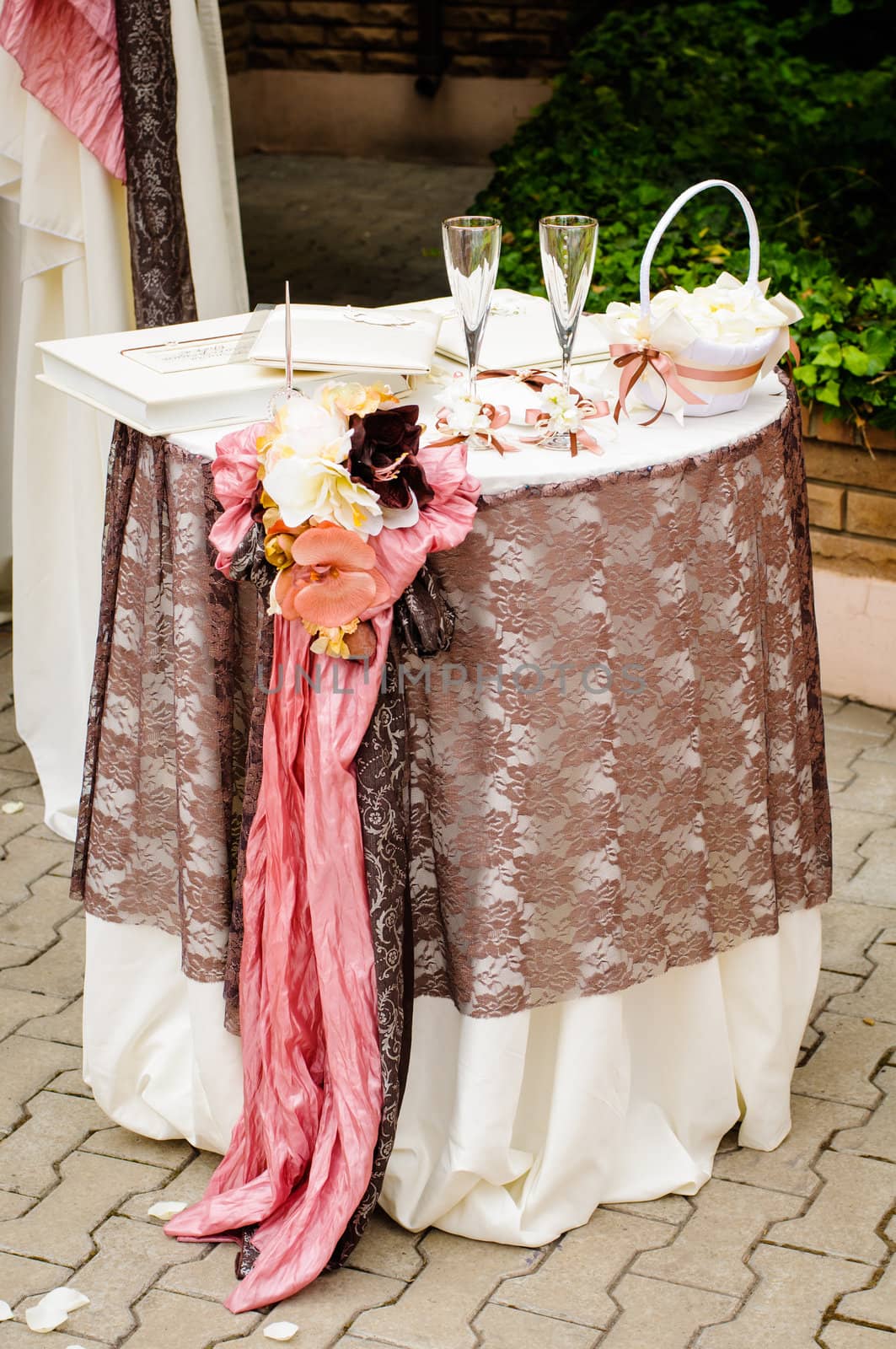 Table with flowers, books and pen for wedding ceremony