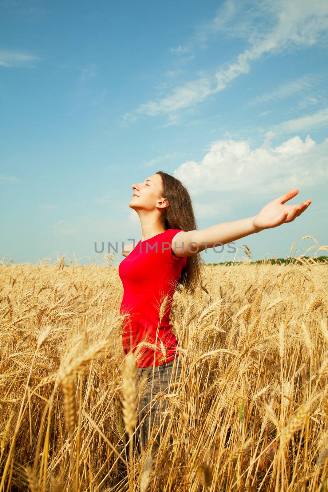 Teen girl staying at a wheat field by AndreyKr