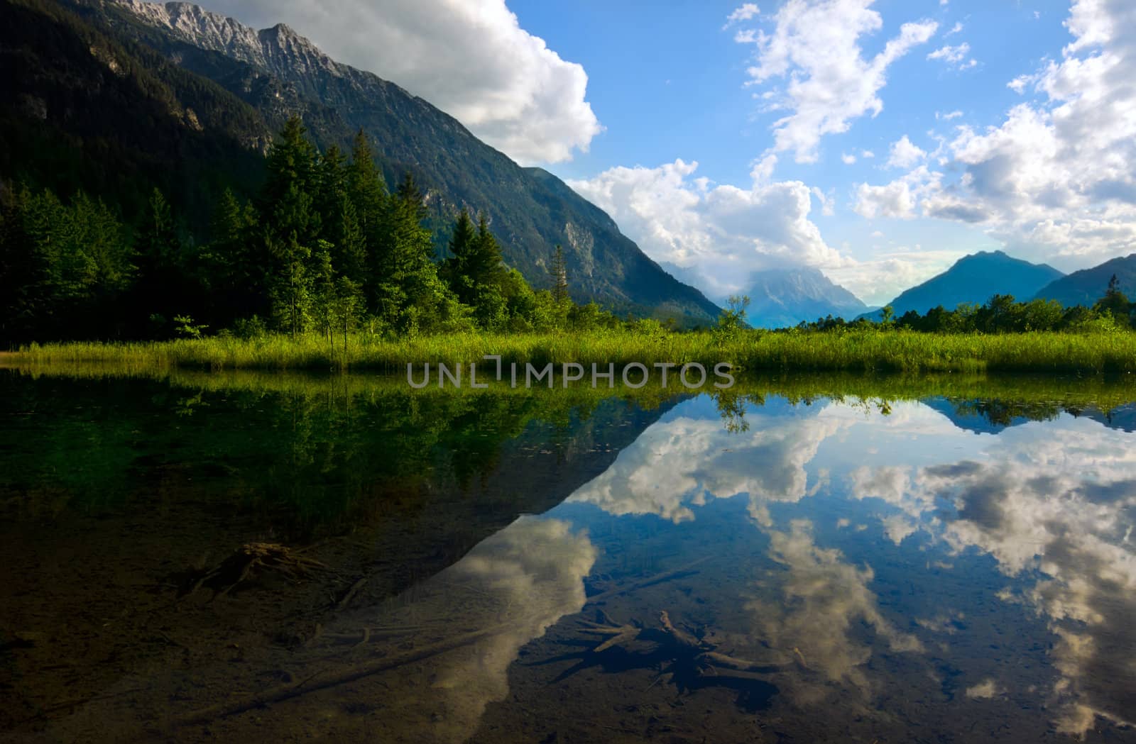 reflection of Alps and sky in alpine lake