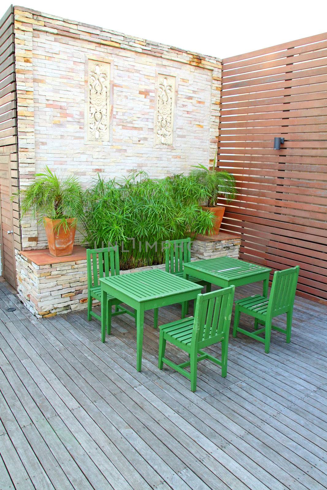 Green table setting on rooftop outdoor by nuchylee