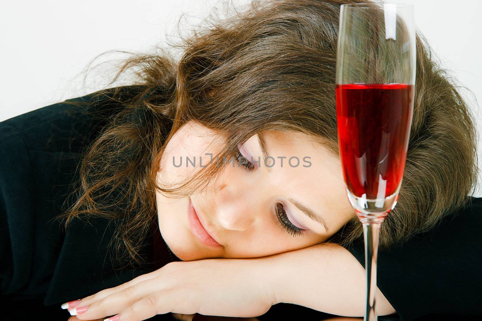 Sleeping girl and a glass of wine