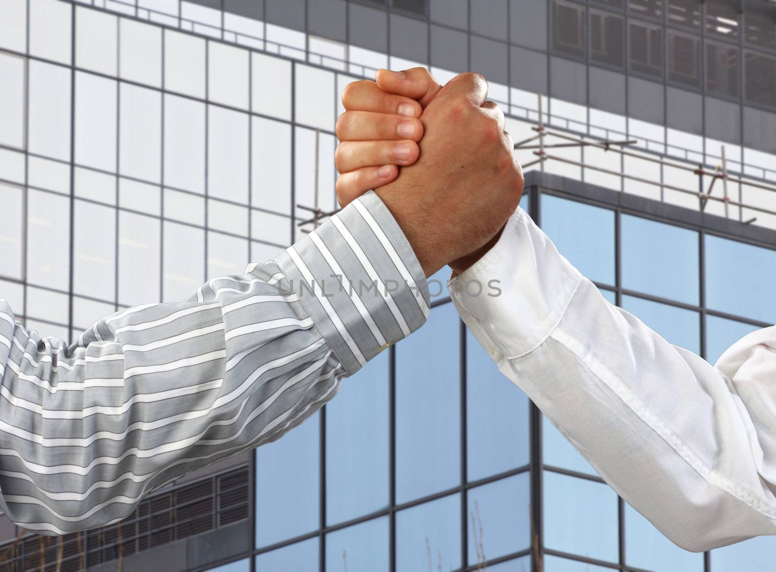 Arm wrestling in the office  over business corporate building