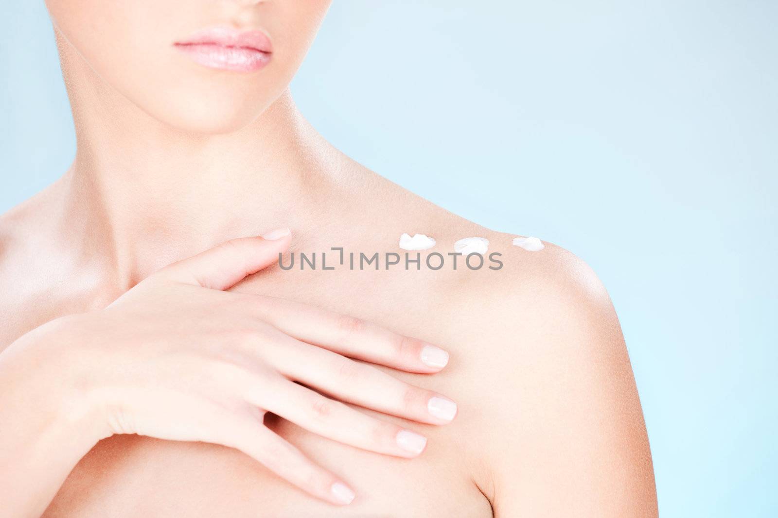 cosmetic cream on woman's shoulder by imarin