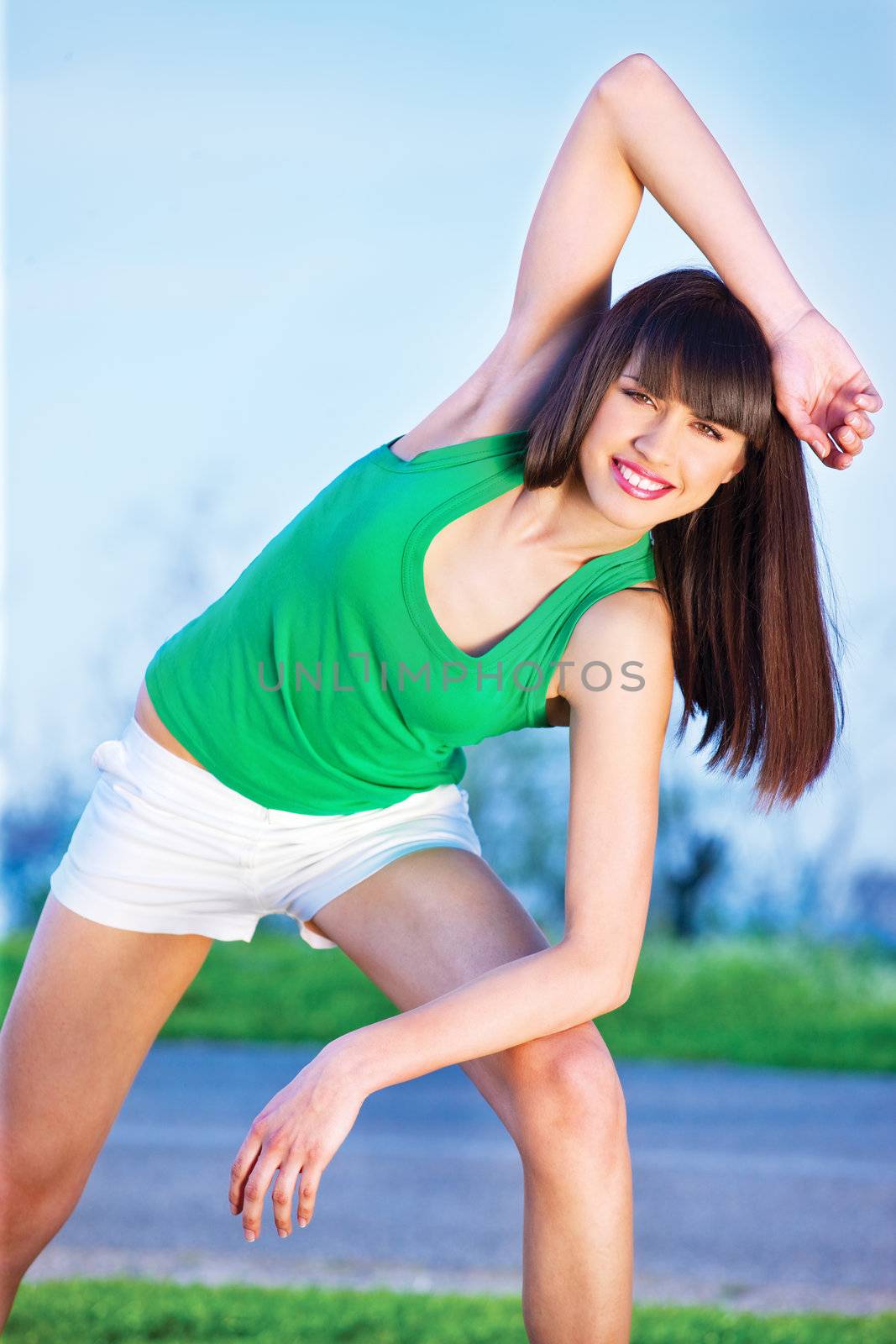 Pretty woman doing exercise outdoors