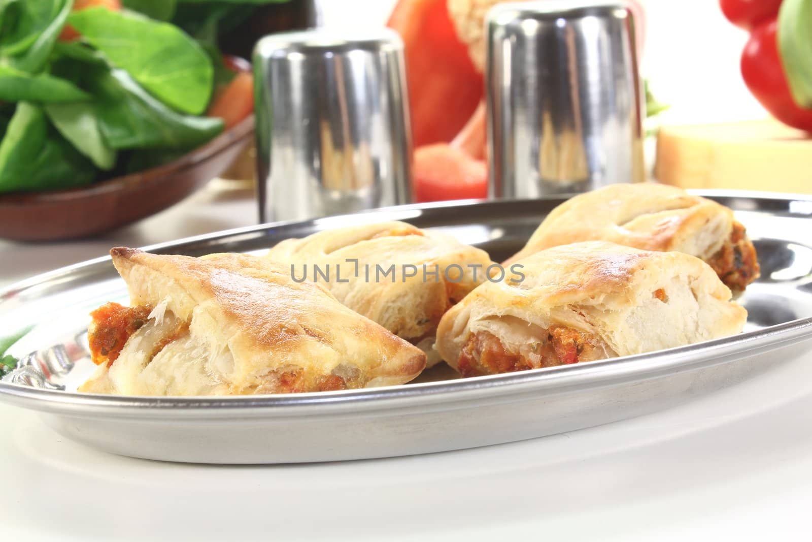 Puff pastry with bell peppers and Cheese filling on a light background