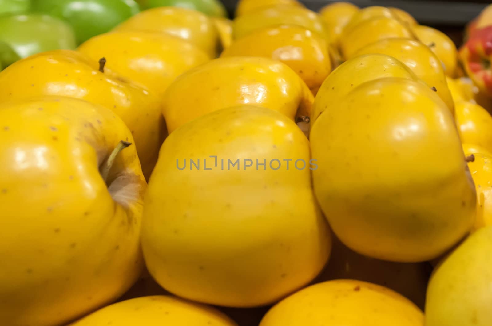 yellow apples on display at farmers market