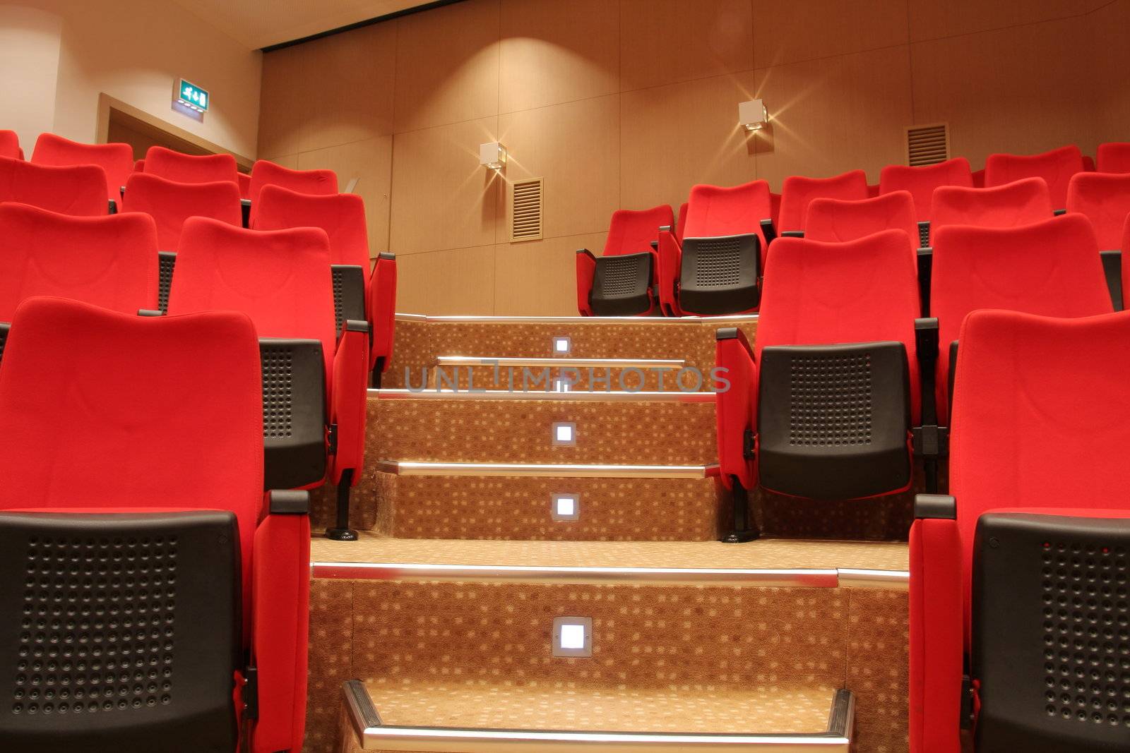 Stairs in theatre with red empty chairs