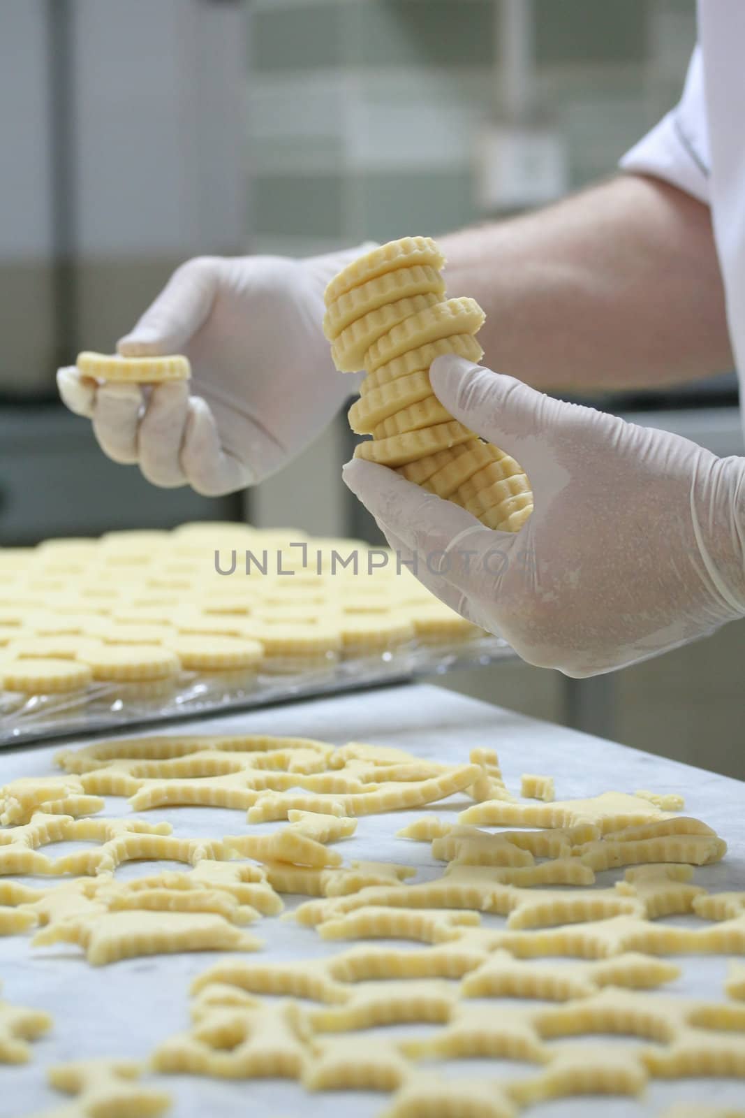 Pastry making biscuits with white gloves
