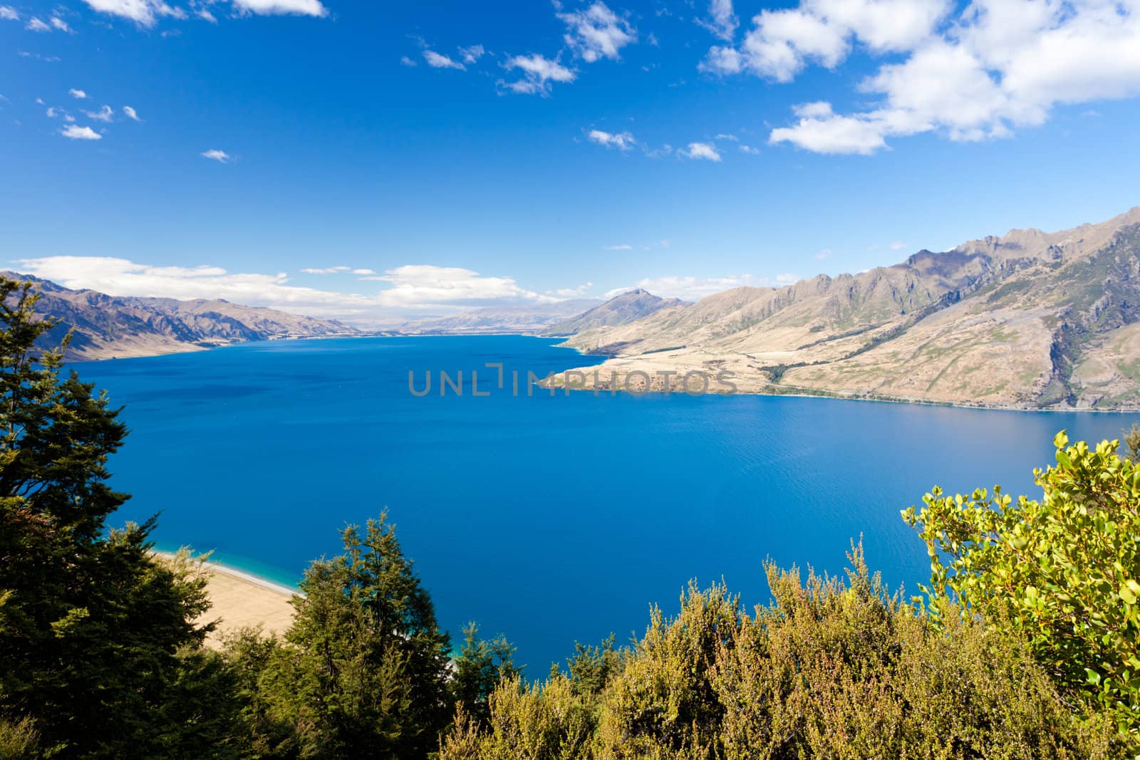 Vivid blue surface of big mountain Lake Hawea, Central Otago, New Zealand