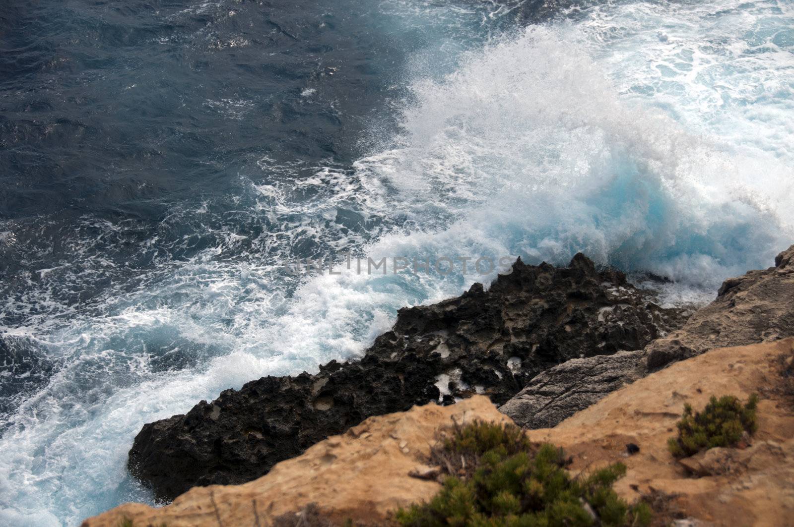 heavy waves on the island Malta with very blue water