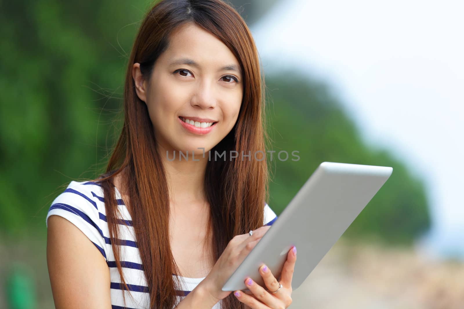 asian woman using tablet computer by leungchopan