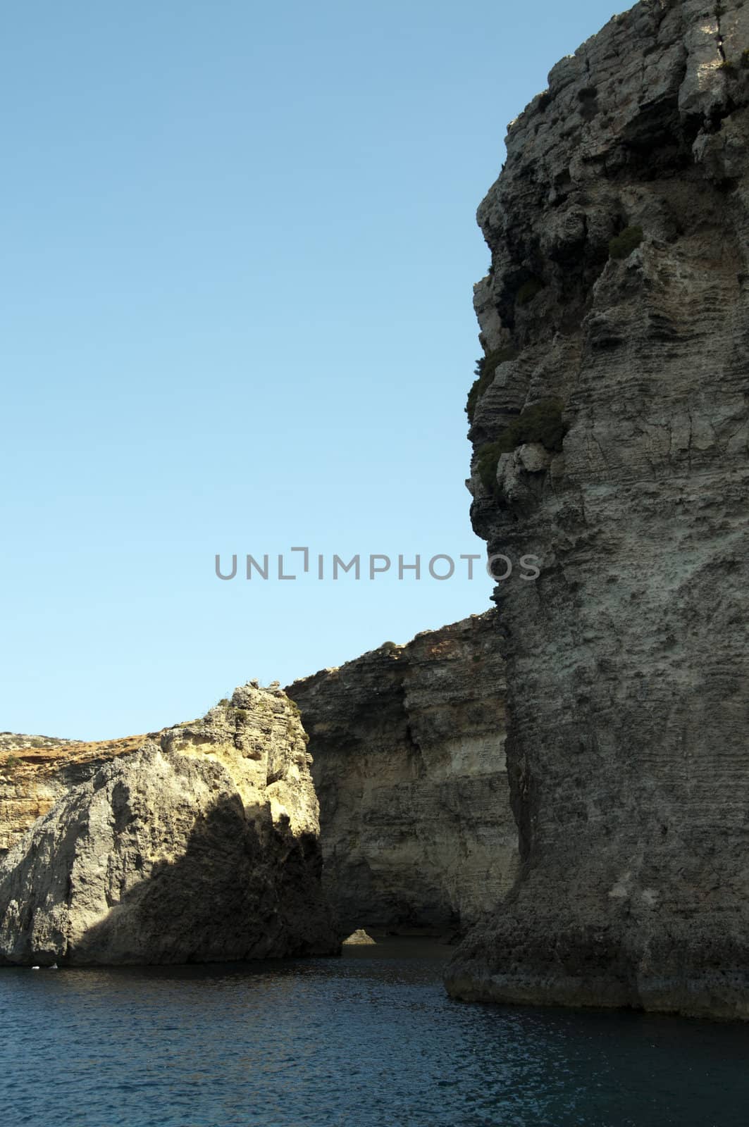 Blue sea and rocks on the malta beach by compuinfoto