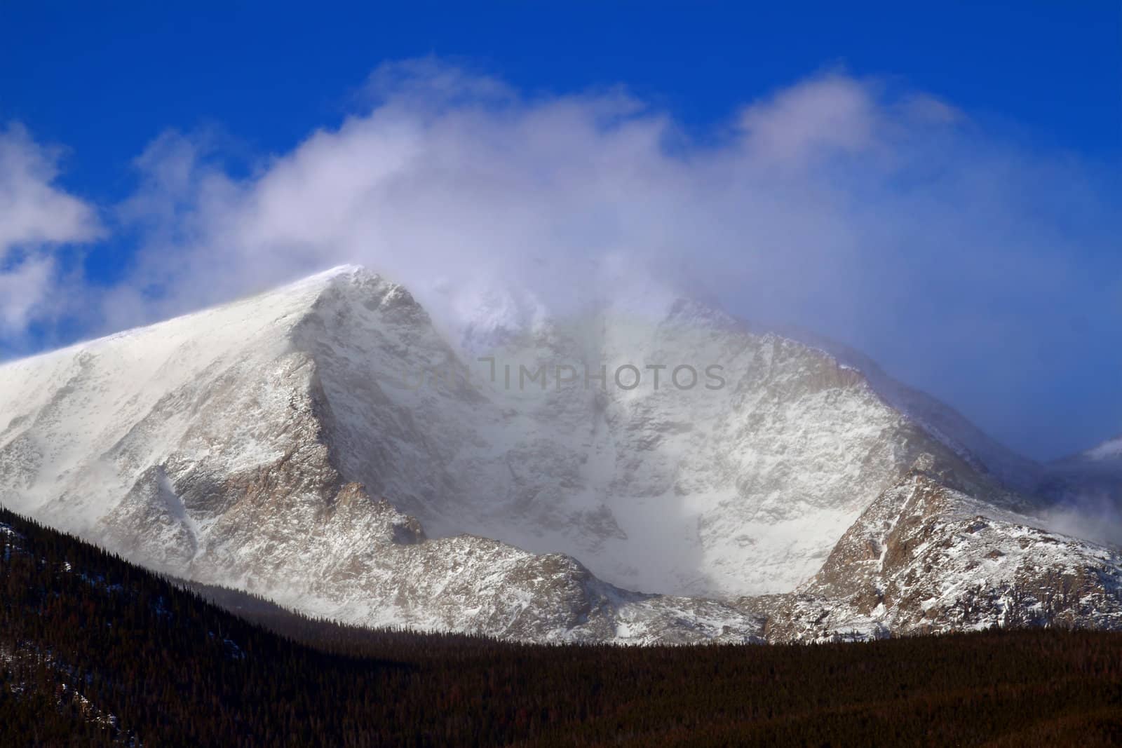 Intense winds create a fog of snow over Mount Ypsilon of Rocky Mountain National Park in Colorado.