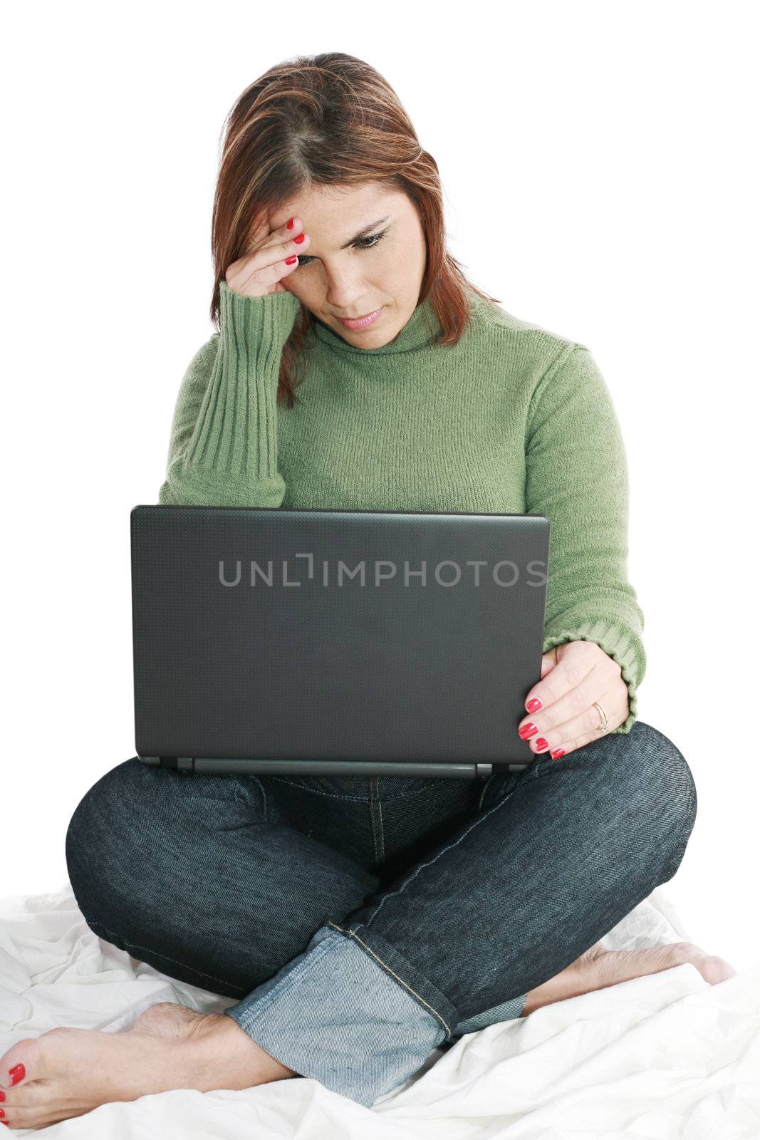 Pretty woman deep in thought while looking at laptop