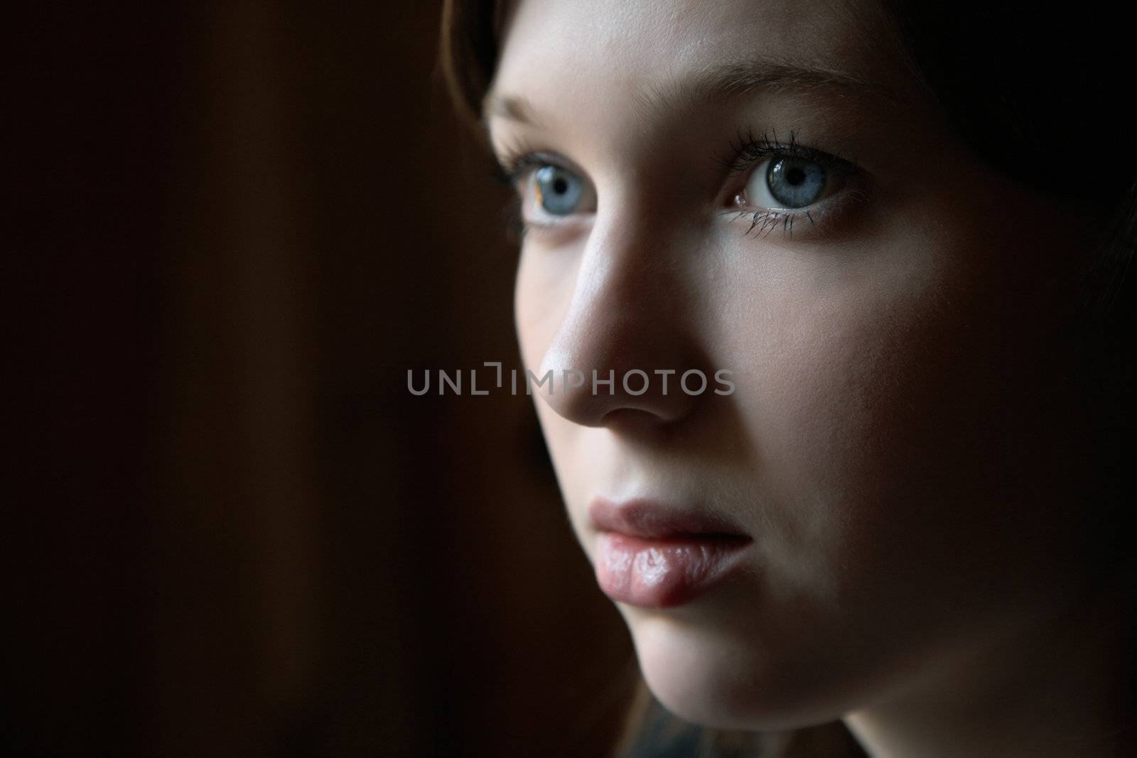Portrait of the girl in a dark tonality on close-up