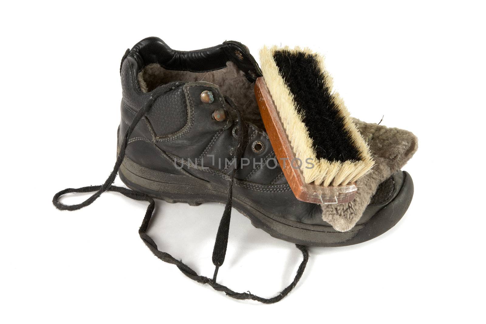 Old boot with  shoe brush on a white background