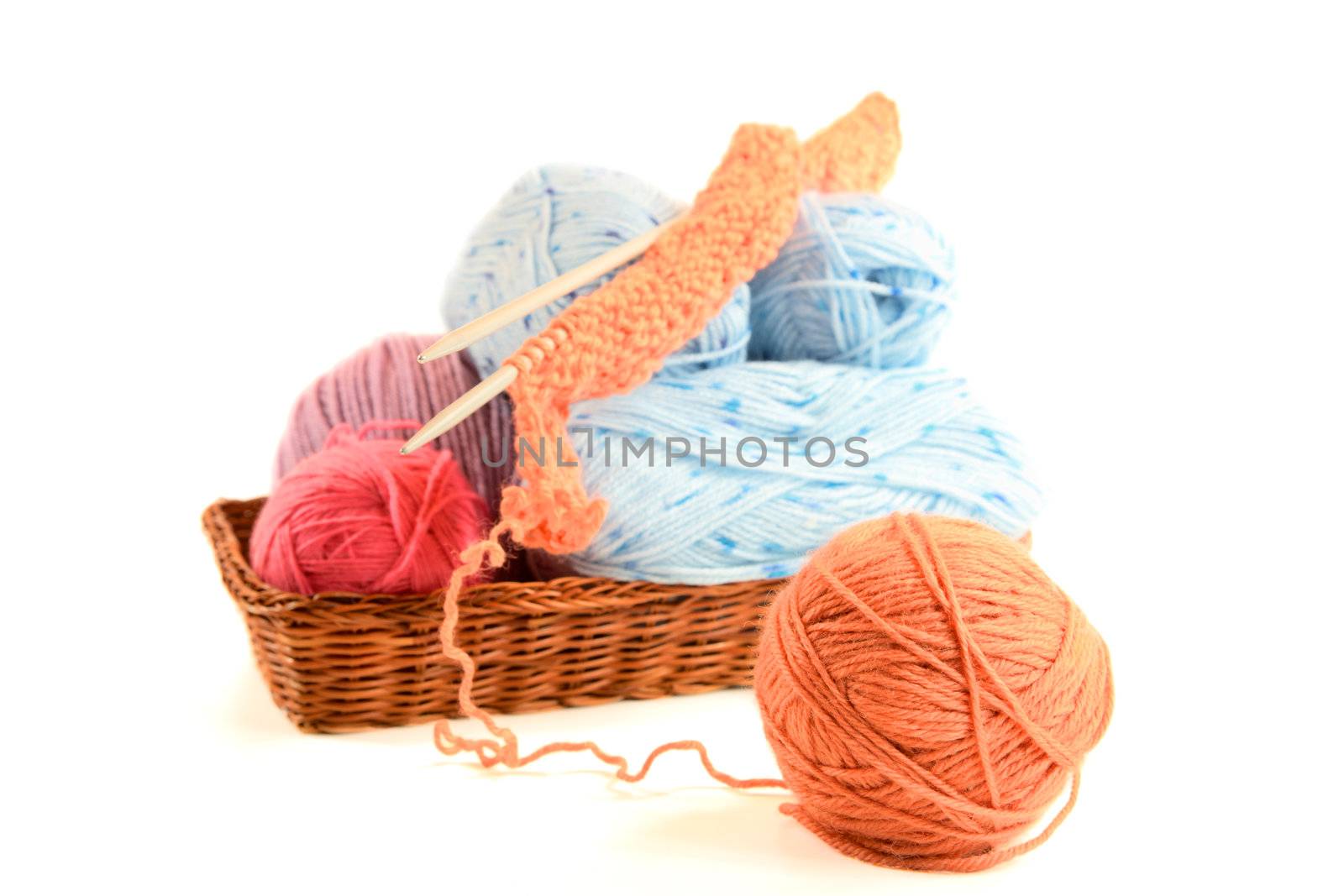 multicolored clews in   basket isolated on a white background