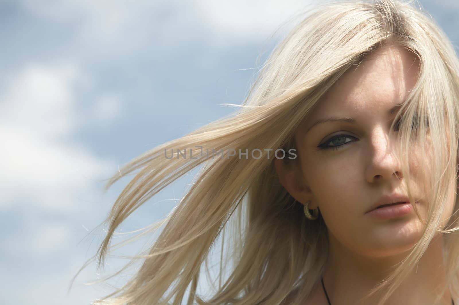  beautiful girl on a background of the blue sky