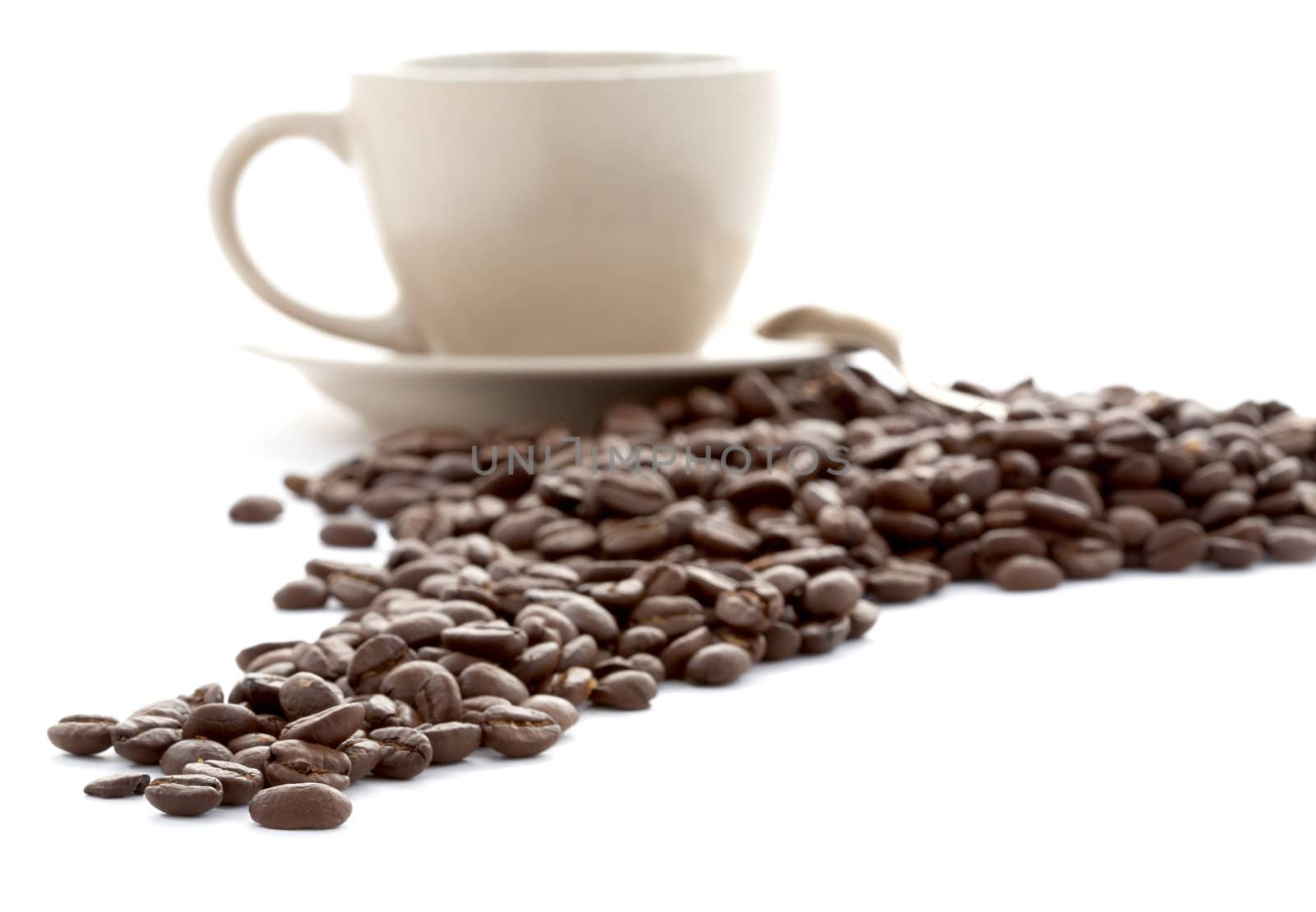 Cup and coffee grains on a white background
