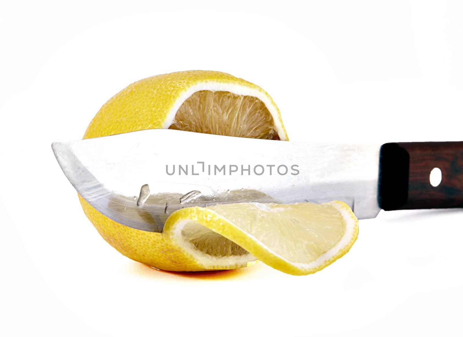 Knife a cutting juicy lemon on a white background