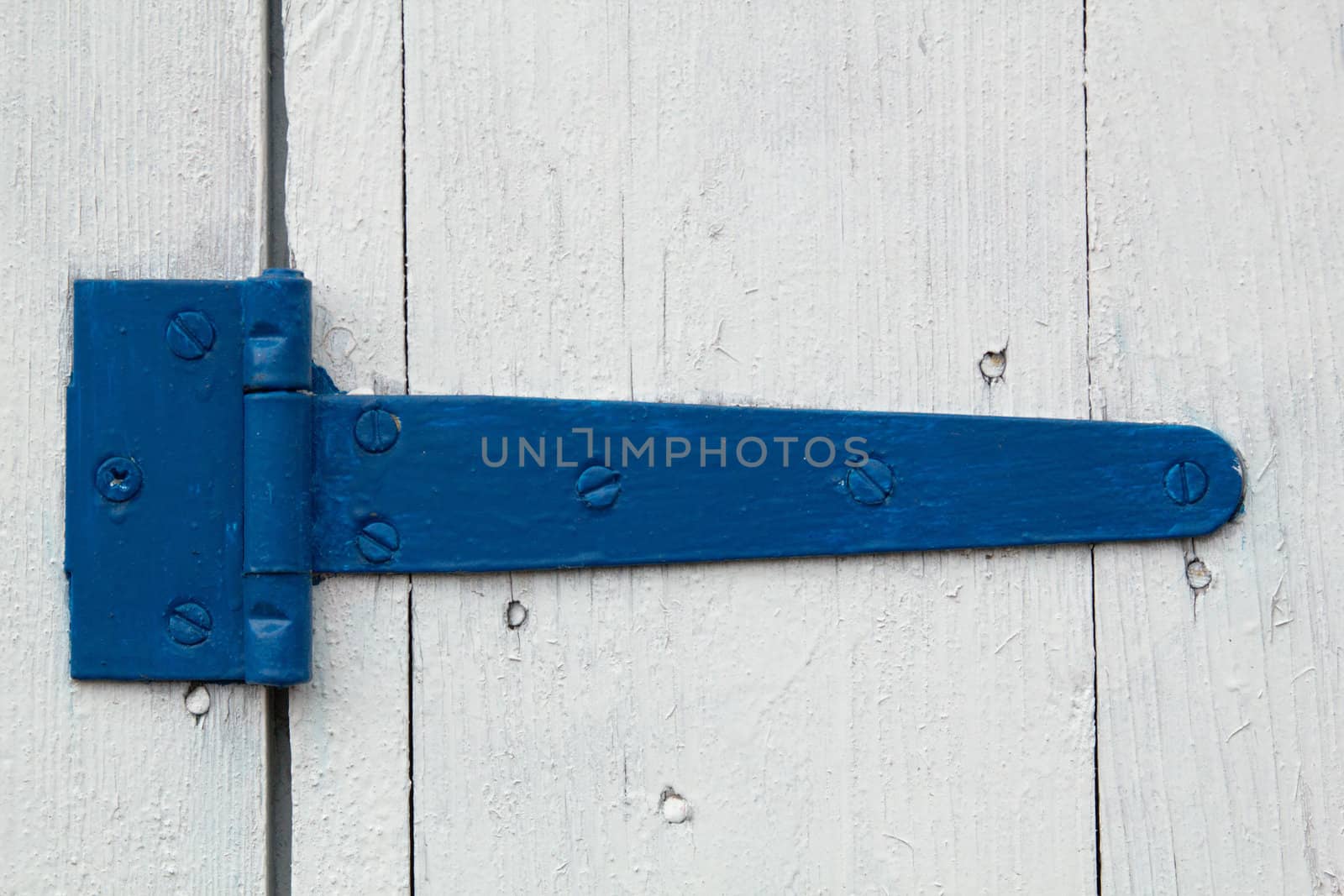 Blue door hinge, on a white painted doors